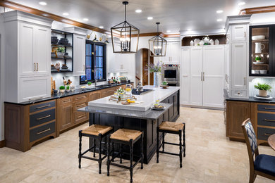 Example of a large cottage l-shaped marble floor enclosed kitchen design in Oklahoma City with an undermount sink, white cabinets, quartz countertops, white backsplash, porcelain backsplash, paneled appliances, an island and black countertops