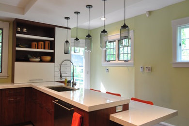 Example of a large trendy l-shaped light wood floor enclosed kitchen design in Chicago with an undermount sink, flat-panel cabinets, medium tone wood cabinets, quartz countertops, multicolored backsplash, ceramic backsplash, stainless steel appliances and a peninsula