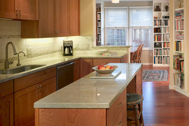 Inspiration for a large transitional u-shaped medium tone wood floor enclosed kitchen remodel in San Francisco with an undermount sink, shaker cabinets, medium tone wood cabinets, granite countertops, ceramic backsplash, an island and stainless steel appliances