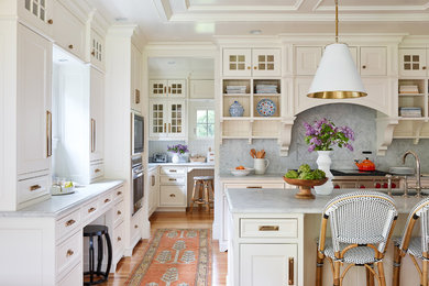 Eat-in kitchen - large traditional l-shaped medium tone wood floor and brown floor eat-in kitchen idea in Boston with an undermount sink, beaded inset cabinets, white cabinets, marble countertops, white backsplash, marble backsplash, paneled appliances, an island and gray countertops