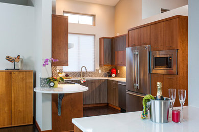 Example of a transitional kitchen design in Seattle with a drop-in sink, flat-panel cabinets, brown cabinets, quartz countertops, brown backsplash, mosaic tile backsplash and stainless steel appliances