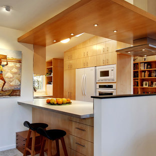 Enclosed kitchen - contemporary enclosed kitchen idea in Seattle with flat-panel cabinets, light wood cabinets and white appliances