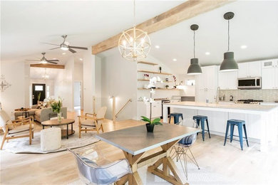 Eat-in kitchen - mid-sized country u-shaped light wood floor and gray floor eat-in kitchen idea in Other with a farmhouse sink, recessed-panel cabinets, white cabinets, marble countertops, gray backsplash, ceramic backsplash, stainless steel appliances, an island and white countertops