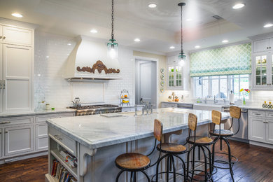 Large transitional u-shaped dark wood floor open concept kitchen photo in Phoenix with a farmhouse sink, white cabinets, white backsplash, subway tile backsplash, stainless steel appliances and an island