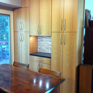 Mid-sized contemporary enclosed kitchen designs - Example of a mid-sized trendy u-shaped bamboo floor enclosed kitchen design in Philadelphia with an undermount sink, flat-panel cabinets, light wood cabinets, granite countertops, multicolored backsplash, porcelain backsplash, stainless steel appliances and no island