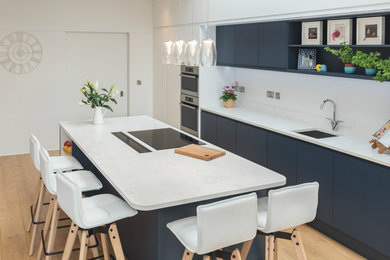 Zweizeilige, Mittelgroße Moderne Wohnküche mit Quarzit-Arbeitsplatte, Kücheninsel und weißer Arbeitsplatte in Dublin