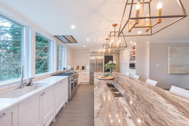 Kitchen pantry - huge modern u-shaped porcelain tile and gray floor kitchen pantry idea in Vancouver with an undermount sink, shaker cabinets, white cabinets, quartz countertops, white backsplash, porcelain backsplash, stainless steel appliances and an island