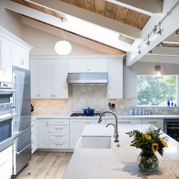 Exposed Beam Ceiling and White Cabinets in this Expansive Kitchen Remodel
