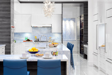 Example of a mid-sized minimalist u-shaped marble floor and beige floor eat-in kitchen design in Toronto with flat-panel cabinets, white cabinets, quartzite countertops, blue backsplash, stainless steel appliances and an island