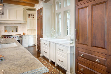 Inspiration for a timeless medium tone wood floor open concept kitchen remodel in Columbus with an undermount sink, raised-panel cabinets, medium tone wood cabinets and an island