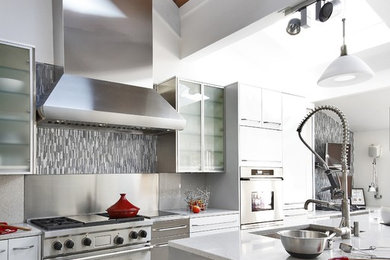 Inspiration for a mid-sized modern l-shaped cement tile floor eat-in kitchen remodel in Baltimore with an undermount sink, granite countertops, multicolored backsplash, stainless steel appliances, flat-panel cabinets, white cabinets, matchstick tile backsplash and an island