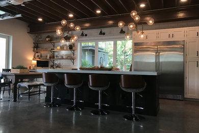 Inspiration for a huge farmhouse galley concrete floor and gray floor open concept kitchen remodel in Orlando with a triple-bowl sink, recessed-panel cabinets, white cabinets, quartzite countertops, white backsplash, subway tile backsplash, stainless steel appliances, an island and white countertops