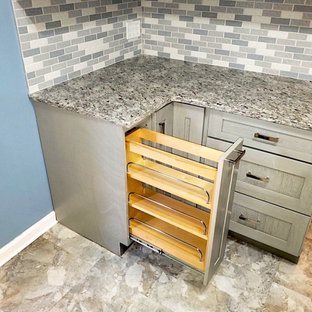 Small modern galley separate kitchen in DC Metro with an undermount sink, shaker cabinets, grey cabinets, granite benchtops, grey splashback, mosaic tile splashback, stainless steel appliances, vinyl floors, beige floor and grey benchtop.