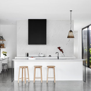 Design ideas for a contemporary u-shaped kitchen in Melbourne with with island, louvered cabinets, white cabinets, white splashback, white appliances, grey floor and white benchtop.