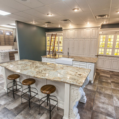 Kitchen - large transitional galley kitchen idea in Other with a farmhouse sink, granite countertops, glass-front cabinets, beige cabinets and an island
