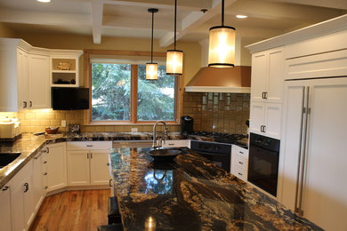 Large mountain style u-shaped medium tone wood floor and brown floor kitchen photo in Salt Lake City with an undermount sink, shaker cabinets, white cabinets, granite countertops, yellow backsplash, subway tile backsplash, black appliances, an island and black countertops