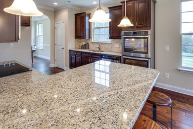 Trendy eat-in kitchen photo in Other with granite countertops