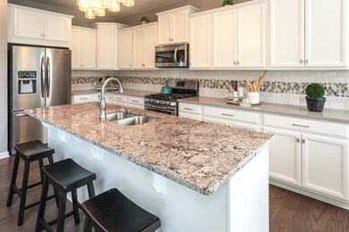 Transitional eat-in kitchen photo in Other with granite countertops