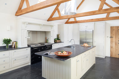 This is an example of a large contemporary l-shaped kitchen/diner in Kent with a submerged sink, shaker cabinets, granite worktops, glass sheet splashback, slate flooring and an island.