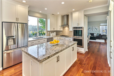 Eat-in kitchen - mid-sized contemporary l-shaped medium tone wood floor and brown floor eat-in kitchen idea in San Francisco with an undermount sink, shaker cabinets, white cabinets, granite countertops, gray backsplash, subway tile backsplash, stainless steel appliances and an island