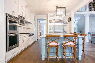 Exempel på ett klassiskt kök, med en undermonterad diskho, skåp i shakerstil, träbänkskiva, stänkskydd i tunnelbanekakel, rostfria vitvaror, mellanmörkt trägolv, en köksö och brunt golv