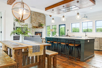 Large french country galley medium tone wood floor, brown floor and exposed beam eat-in kitchen photo in Grand Rapids with a farmhouse sink, recessed-panel cabinets, blue cabinets, quartz countertops, white backsplash, ceramic backsplash, stainless steel appliances, an island and white countertops