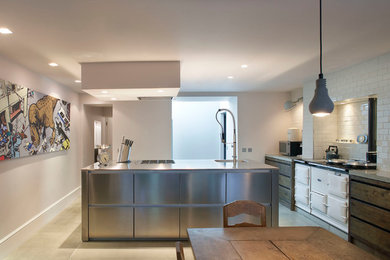 Contemporary kitchen in London with white appliances.