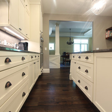 Family House Kitchen with Dark Backsplash and Granite Countertops