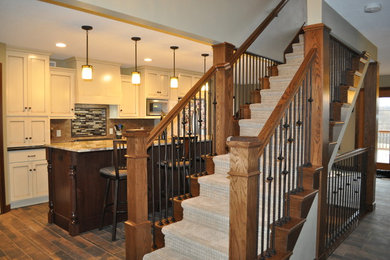 Transitional ceramic tile and brown floor eat-in kitchen photo in Minneapolis with an undermount sink, recessed-panel cabinets, white cabinets, granite countertops, brown backsplash, ceramic backsplash, stainless steel appliances and an island