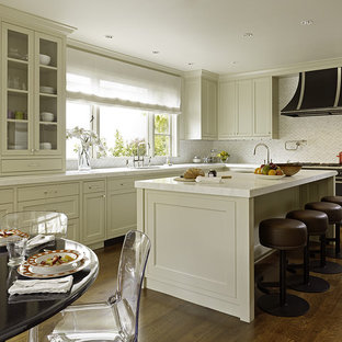 Example of a transitional kitchen design in San Francisco with recessed-panel cabinets, beige cabinets, white backsplash and black appliances