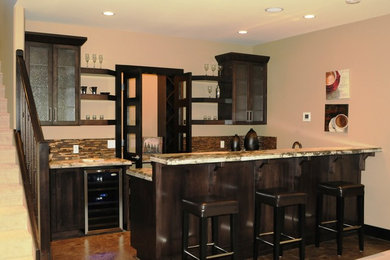Example of a trendy home bar design in Calgary