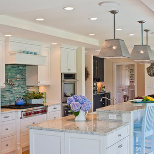 Mid-sized traditional eat-in kitchen ideas - Inspiration for a mid-sized timeless galley light wood floor and brown floor eat-in kitchen remodel in Boston with shaker cabinets, white cabinets, paneled appliances, glass tile backsplash, an undermount sink, quartz countertops and an island