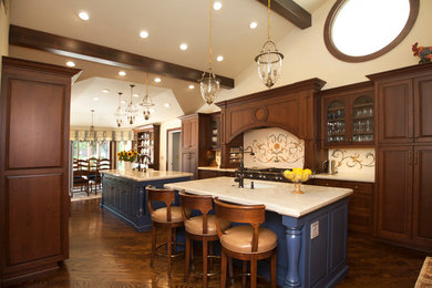 Large tuscan u-shaped medium tone wood floor and brown floor open concept kitchen photo in San Francisco with two islands, beaded inset cabinets, medium tone wood cabinets, granite countertops, beige backsplash, stainless steel appliances, a farmhouse sink and mosaic tile backsplash