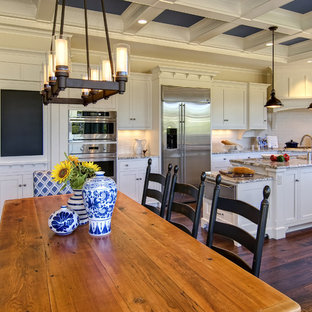 Traditional kitchen designs - Elegant kitchen photo in Other with stainless steel appliances and subway tile backsplash