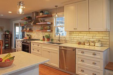Mid-sized country u-shaped medium tone wood floor and brown floor eat-in kitchen photo in Minneapolis with an undermount sink, shaker cabinets, white cabinets, quartz countertops, white backsplash, ceramic backsplash, stainless steel appliances and a peninsula