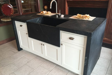 Mid-sized elegant u-shaped porcelain tile kitchen photo in Other with a farmhouse sink, shaker cabinets, white cabinets and granite countertops