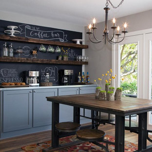 Inspiration for a medium sized country kitchen/diner in New York with shaker cabinets, blue cabinets, black splashback and medium hardwood flooring.