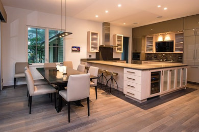 This is an example of a large contemporary u-shaped kitchen/diner in Other with a submerged sink, flat-panel cabinets, grey cabinets, composite countertops, multi-coloured splashback, matchstick tiled splashback, coloured appliances, dark hardwood flooring, a breakfast bar and brown floors.