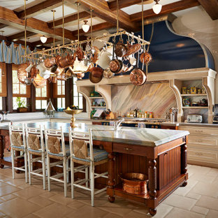 Photo of an expansive mediterranean l-shaped eat-in kitchen in Tampa with a farmhouse sink, flat-panel cabinets, medium wood cabinets, granite benchtops, multi-coloured splashback, granite splashback, panelled appliances, ceramic floors, with island, beige floor and grey benchtop.