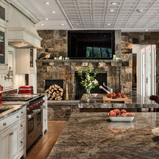 This is an example of a small country single-wall eat-in kitchen in New York with beaded inset cabinets, distressed cabinets, granite benchtops, stainless steel appliances, multiple islands, an undermount sink, white splashback, subway tile splashback, medium hardwood floors and beige floor.