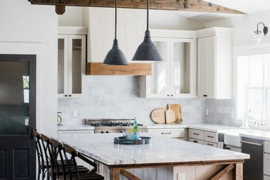 Example of a mid-sized farmhouse l-shaped dark wood floor and brown floor open concept kitchen design in Columbus with a farmhouse sink, white cabinets, marble countertops, white backsplash, marble backsplash, stainless steel appliances, an island and white countertops