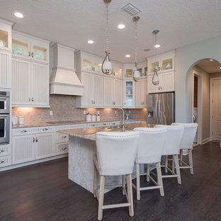 Design ideas for a mid-sized country single-wall eat-in kitchen in Jacksonville with a double-bowl sink, louvered cabinets, white cabinets, marble benchtops, beige splashback, stone tile splashback, stainless steel appliances, vinyl floors and with island.