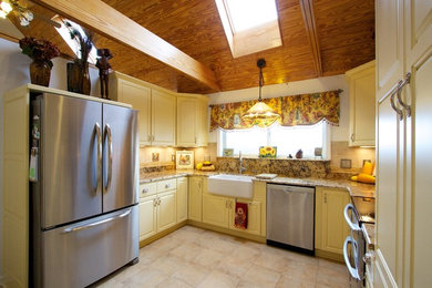 Example of a country eat-in kitchen design in Other with a farmhouse sink, yellow cabinets, granite countertops and stainless steel appliances