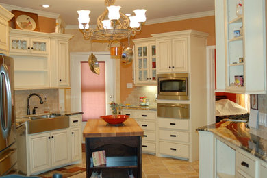 Example of a farmhouse kitchen design in Austin with an island