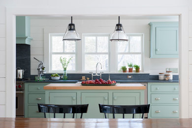 Example of a mid-sized cottage galley eat-in kitchen design in New York with beaded inset cabinets, soapstone countertops, stainless steel appliances, an island and green cabinets