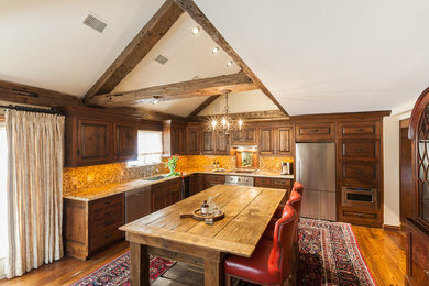 Eat-in kitchen - mid-sized farmhouse l-shaped eat-in kitchen idea in New York with raised-panel cabinets and an island