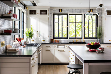 Inspiration for a mid-sized cottage u-shaped light wood floor and brown floor open concept kitchen remodel in New York with an undermount sink, shaker cabinets, gray cabinets, granite countertops, gray backsplash, mosaic tile backsplash, colored appliances and an island