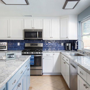 Design ideas for a mid-sized transitional galley separate kitchen in Los Angeles with a single-bowl sink, beaded inset cabinets, white cabinets, granite benchtops, blue splashback, ceramic splashback, stainless steel appliances, ceramic floors, with island, beige floor and blue benchtop.