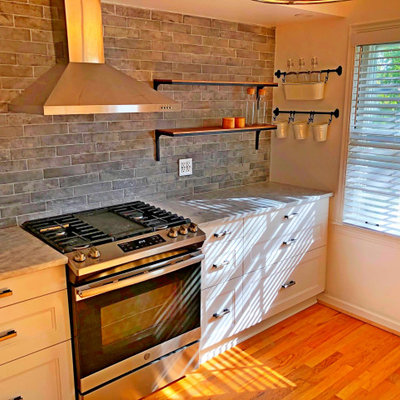 Inspiration for a large cottage single-wall medium tone wood floor and brown floor eat-in kitchen remodel in Detroit with a farmhouse sink, shaker cabinets, white cabinets, granite countertops, gray backsplash, subway tile backsplash, stainless steel appliances, no island and gray countertops