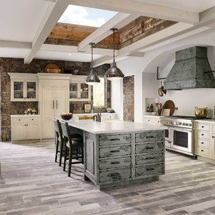 Design ideas for a large transitional l-shaped eat-in kitchen in DC Metro with a farmhouse sink, beaded inset cabinets, white cabinets, quartzite benchtops, beige splashback, slate splashback, stainless steel appliances, porcelain floors, multiple islands, grey floor and multi-coloured benchtop.